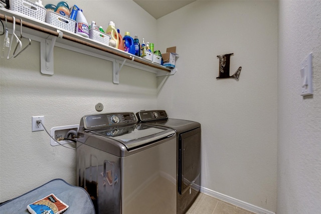 laundry room with light tile patterned floors and washing machine and clothes dryer