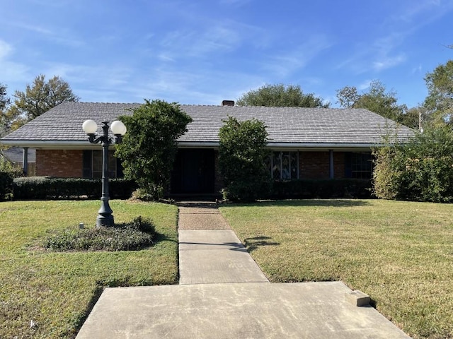 ranch-style house with a front lawn