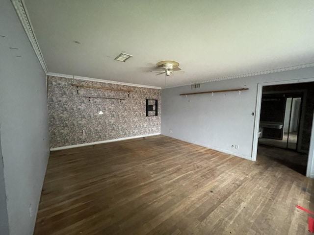 spare room featuring hardwood / wood-style flooring, ceiling fan, and crown molding