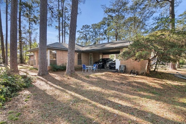 back of property featuring a carport