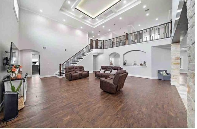 living room featuring dark hardwood / wood-style flooring and a high ceiling