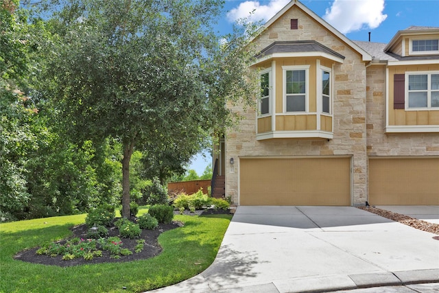 view of front of property featuring a garage and a front yard