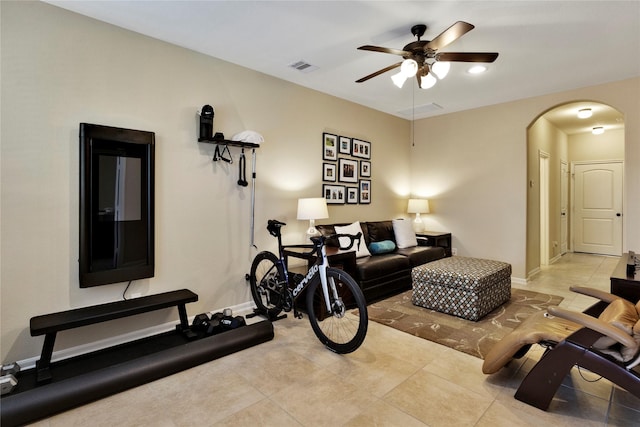 exercise room featuring ceiling fan and light tile patterned floors