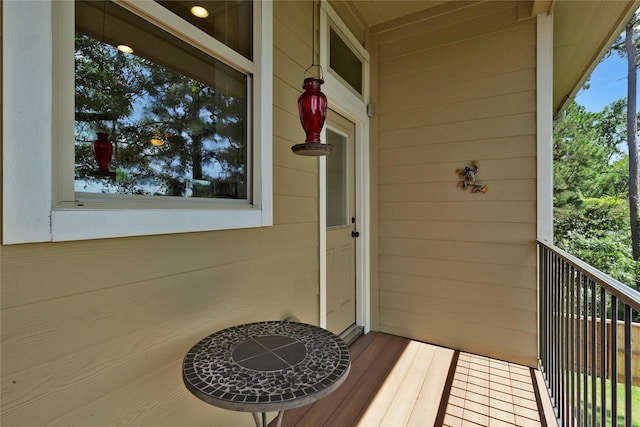 view of exterior entry with a balcony