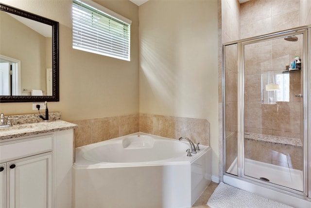 bathroom with separate shower and tub and vanity