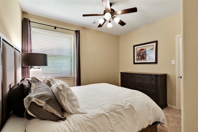 bedroom with ceiling fan and light carpet