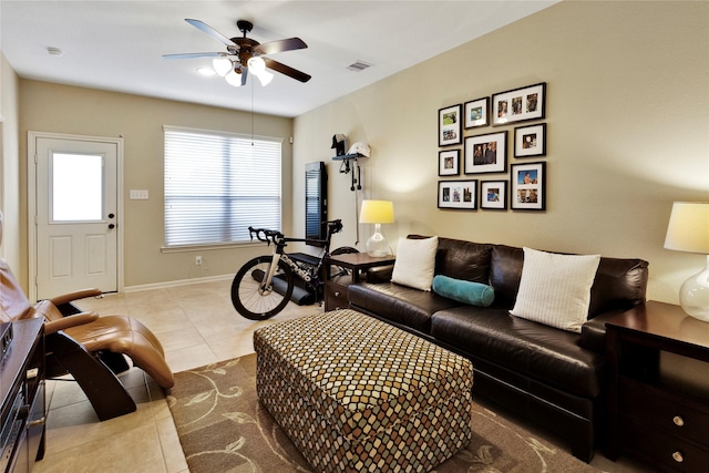 living room featuring ceiling fan and light tile patterned flooring