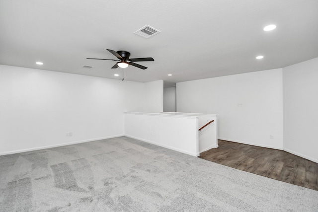 spare room with ceiling fan and carpet