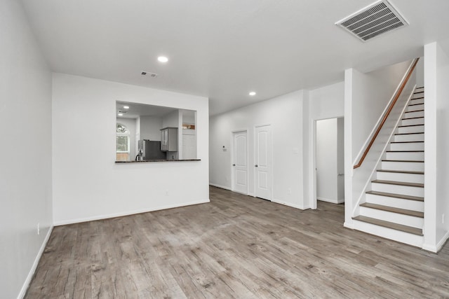 unfurnished living room with light hardwood / wood-style floors