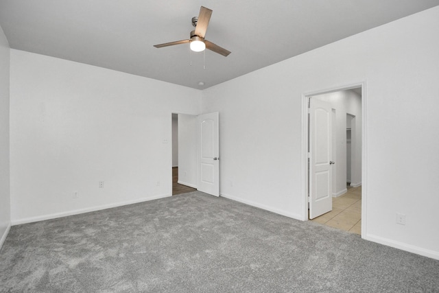 unfurnished bedroom featuring ceiling fan and light colored carpet