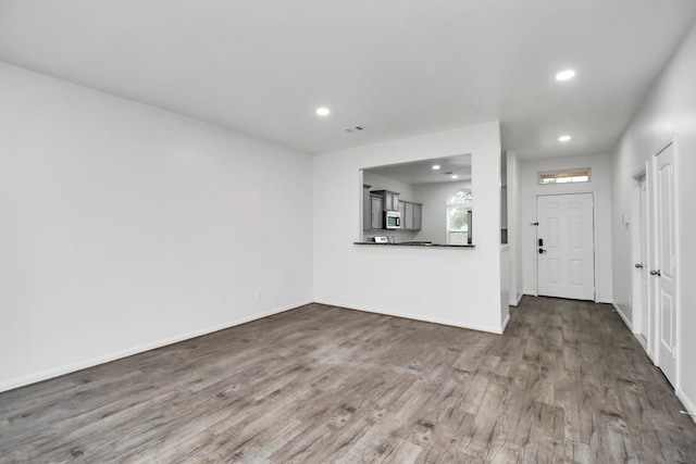 unfurnished living room with dark hardwood / wood-style flooring