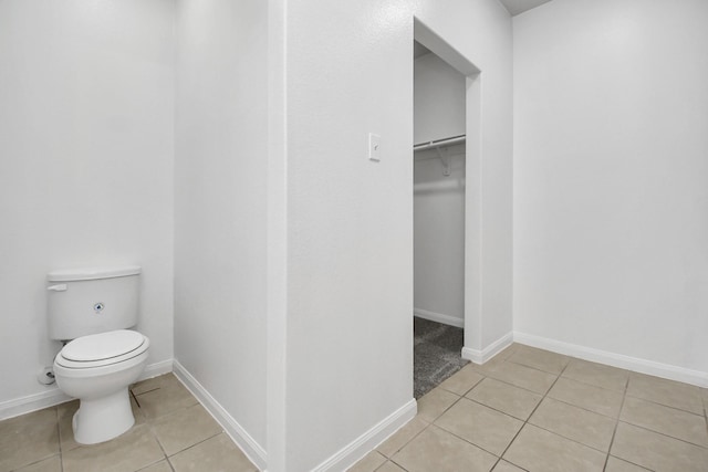 bathroom featuring tile patterned flooring and toilet