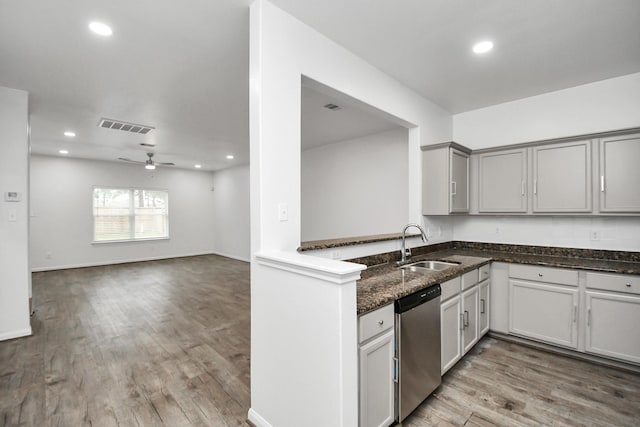 kitchen featuring kitchen peninsula, stainless steel dishwasher, ceiling fan, sink, and light hardwood / wood-style floors