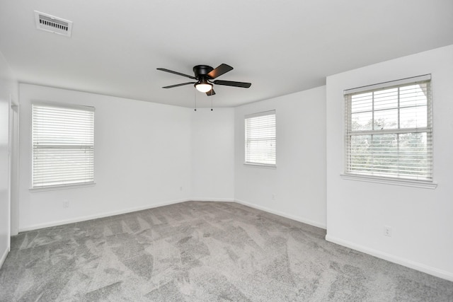 carpeted empty room featuring ceiling fan