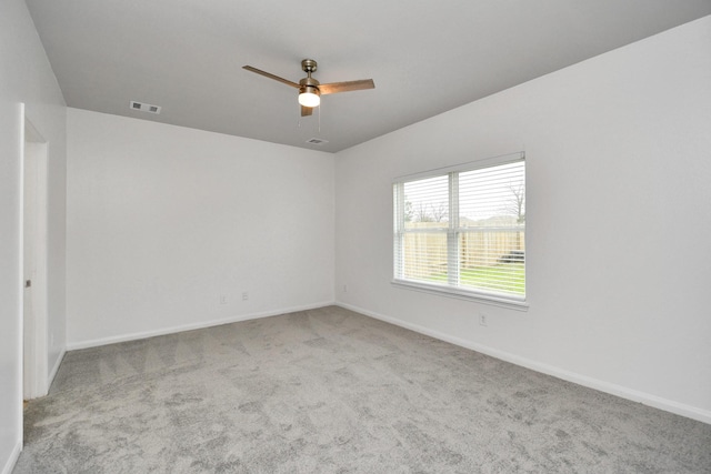 unfurnished room featuring light carpet and ceiling fan