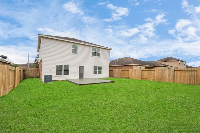 rear view of house featuring cooling unit, a patio area, and a yard