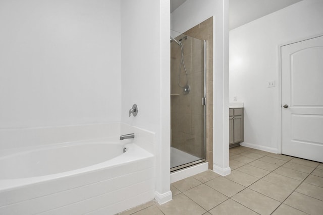 bathroom featuring tile patterned flooring, vanity, and shower with separate bathtub