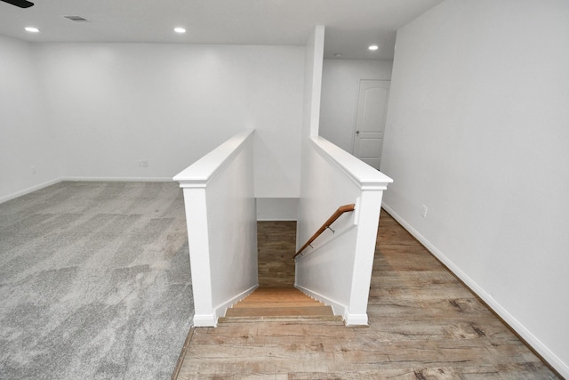 staircase featuring hardwood / wood-style floors