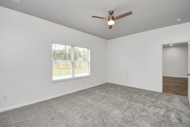 carpeted empty room featuring ceiling fan