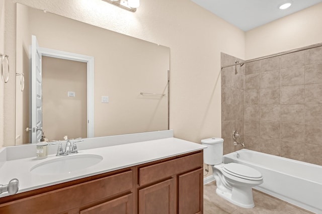 full bathroom featuring tile patterned floors, vanity, tiled shower / bath combo, and toilet