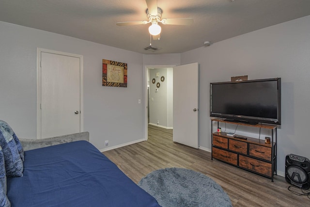 bedroom with ceiling fan and hardwood / wood-style floors