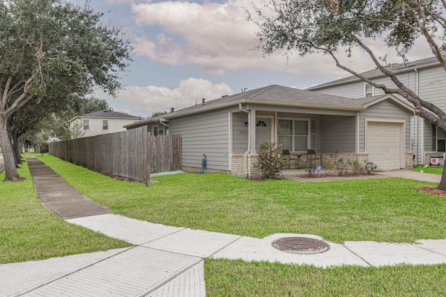 view of front of house with a front yard and a garage