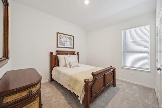 bedroom with light carpet and vaulted ceiling