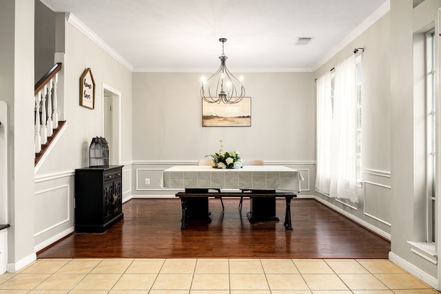 unfurnished dining area with ornamental molding, light tile patterned floors, an inviting chandelier, and breakfast area