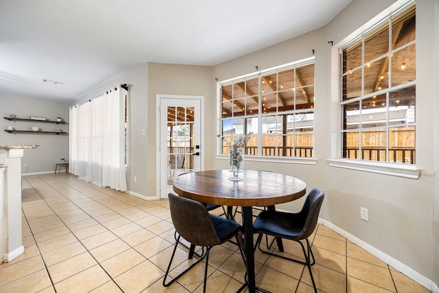 dining room with light tile patterned floors, visible vents, and baseboards