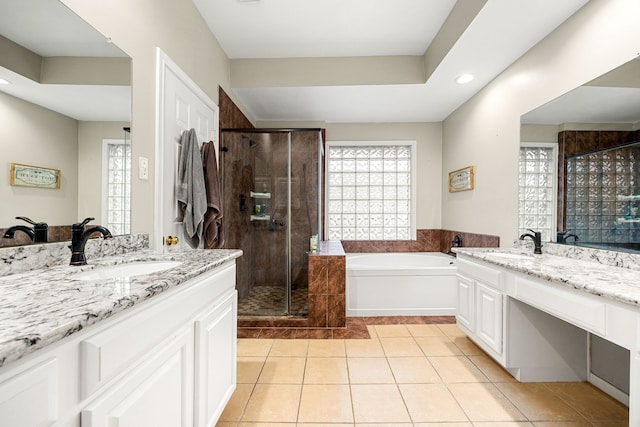 full bath with a bath, a shower stall, a sink, and tile patterned floors