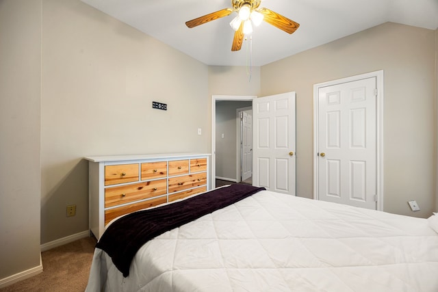 carpeted bedroom featuring lofted ceiling and ceiling fan