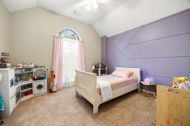 bedroom featuring lofted ceiling, light carpet, visible vents, and a ceiling fan