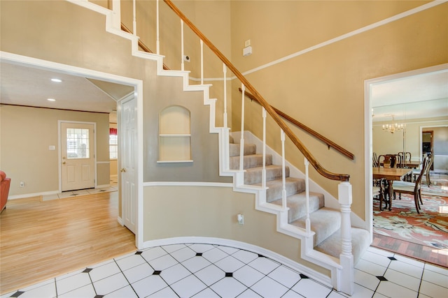 staircase featuring a notable chandelier and tile patterned floors