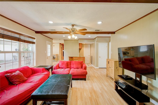 living room featuring crown molding, a textured ceiling, ceiling fan, and light wood-type flooring