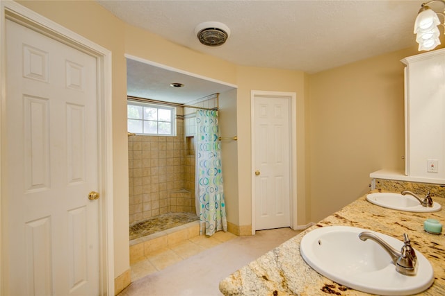 bathroom featuring vanity, tile patterned flooring, and a shower with shower curtain