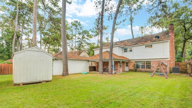 back of property featuring a shed, central AC unit, a patio area, and a lawn