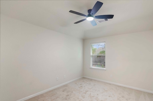 empty room featuring ceiling fan and light colored carpet