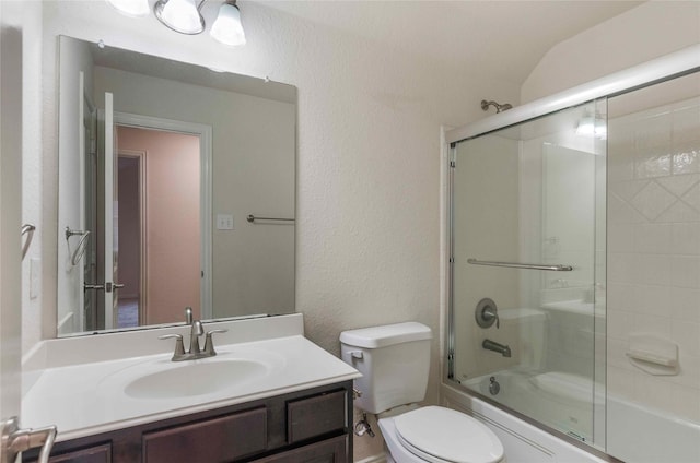 full bathroom featuring vanity, enclosed tub / shower combo, vaulted ceiling, and toilet