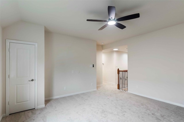 carpeted empty room featuring ceiling fan and vaulted ceiling