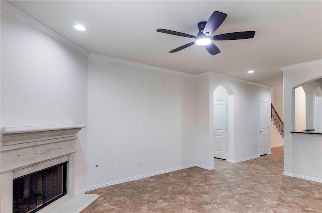 unfurnished living room featuring ceiling fan and crown molding