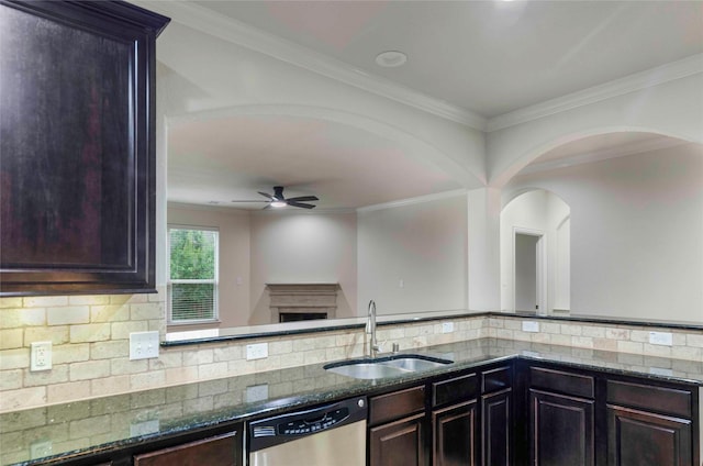 kitchen with ceiling fan, dishwasher, sink, backsplash, and dark stone counters