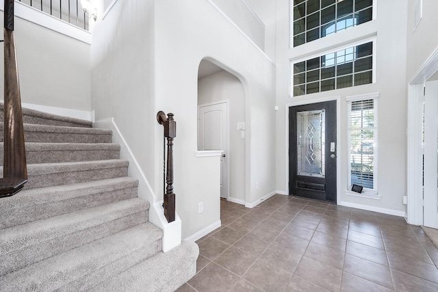 tiled foyer featuring a high ceiling