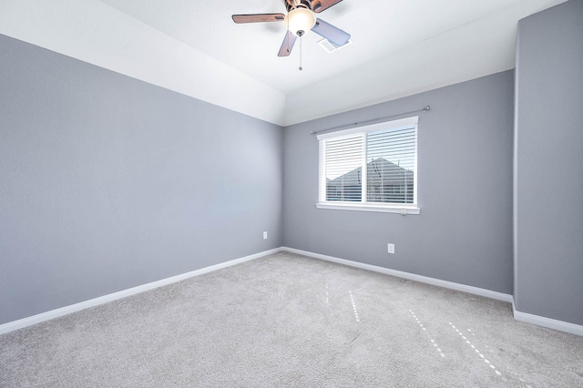 carpeted empty room featuring ceiling fan and lofted ceiling