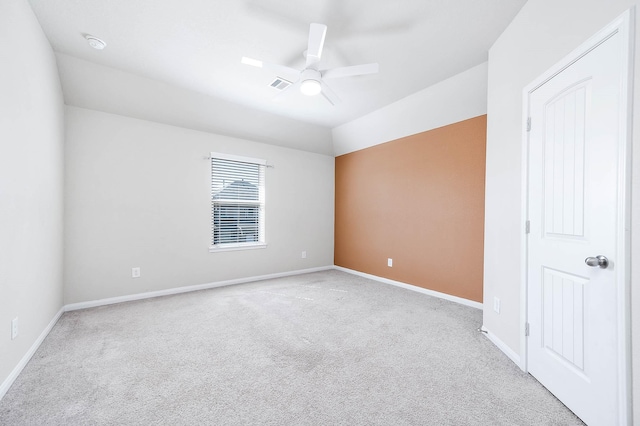 carpeted spare room with ceiling fan