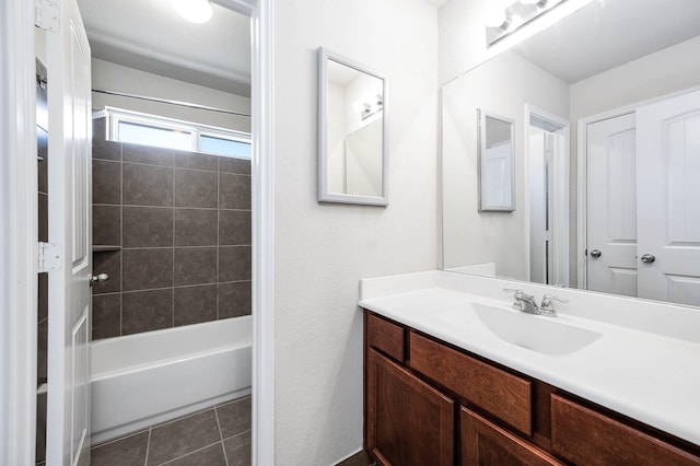 bathroom featuring tile patterned floors, vanity, and tiled shower / bath