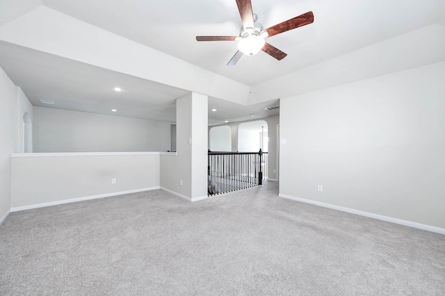 carpeted spare room featuring ceiling fan