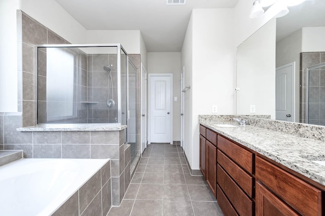 bathroom featuring tile patterned flooring, vanity, and independent shower and bath