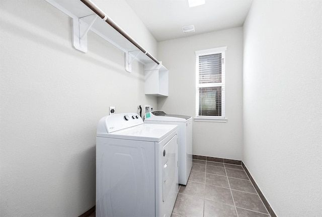 laundry room featuring washer and dryer and light tile patterned floors