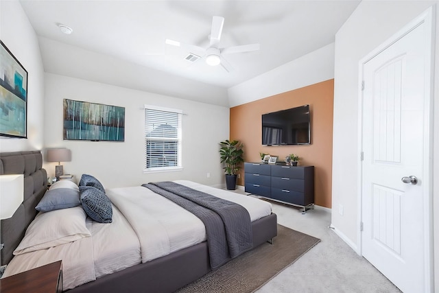 bedroom featuring ceiling fan, light colored carpet, and vaulted ceiling