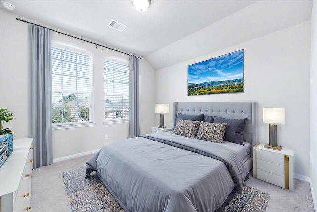 bedroom featuring multiple windows, light carpet, and lofted ceiling